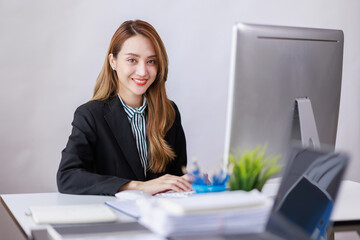 Modern Asian business woman in the home office, doing planning analyzing the financial report,...
