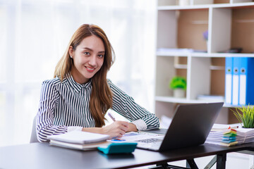 Modern Asian business woman in the home office, doing planning analyzing the financial report, business plan investment, finance analysis concept