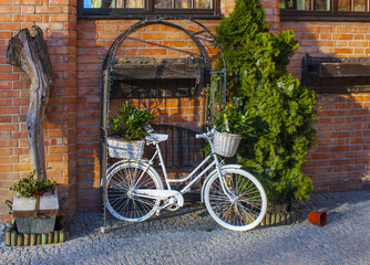 White bike standing on a place next to the restaurant at old town in Gdansk, Poland