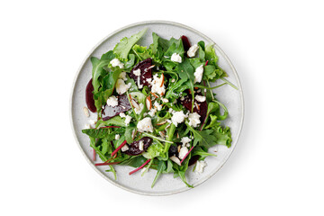 Healthy vegetarian salad, leaves mix salad micro greens, beet, feta cheese, nuts. Meal snack outdoor top view copy space for text. Isolated on white background.