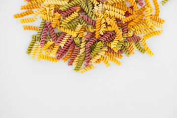 Mixed colorful pasta on white background