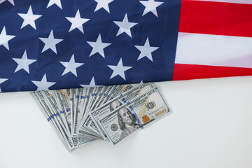 American dollars an USA Flag.Close up of american flag and dollar cash money on white