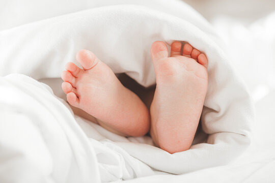 Cute baby`s tiny feet. Infant`s fingers. Closeup picture of child`s feet.