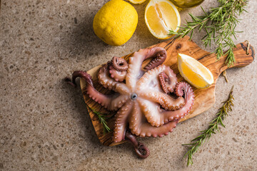 Octopus cooked with chopped herbs served on a  board