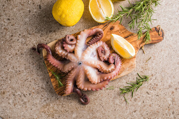 Octopus cooked with chopped herbs served on a  board