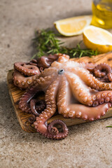 Octopus cooked with chopped herbs served on a  board