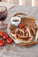 Grilled sausages with sauce and vegetables. Summer rest concept