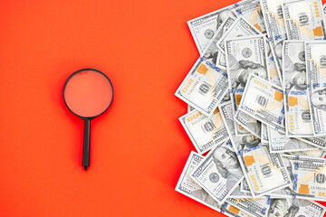 Top view of bundle of 100 dollar bill on red background. Business concept with copy space