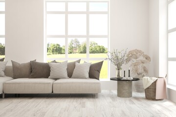 White living room with sofa and summer landscape in window. Scandinavian interior design. 3D illustration