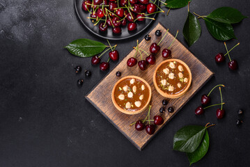 Delicious fresh nougat and nut tart with fresh berries on a wooden cutting board