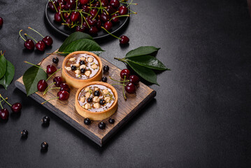 Delicious fresh nougat and nut tart with fresh berries on a wooden cutting board