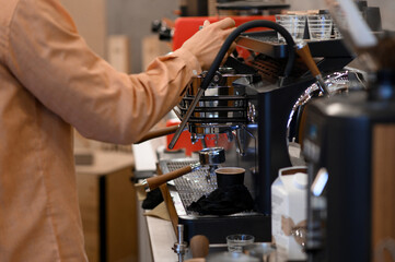 Barista making coffee using a coffee maker