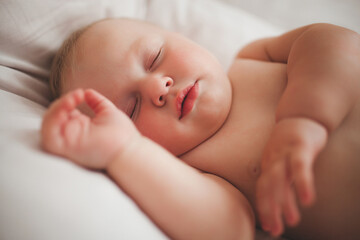 Cute little baby sleeping. Tiny infant`s hands in front.