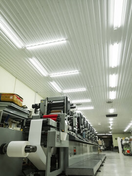 Used modern multi-color roll printing machine for the production of self-adhesive labels. Equipment for printing house. Selective focus