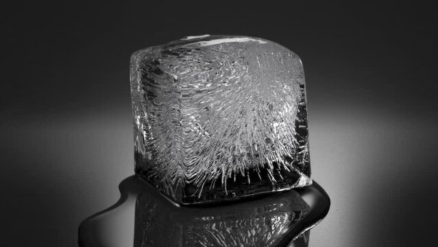 Melting ice cube, water flowing to foreground (viewer). Double speed version. 