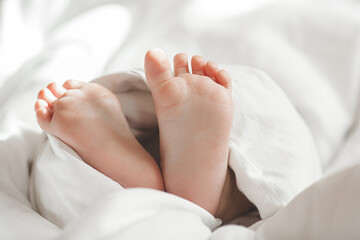 Fototapeta na wymiar Cute baby`s tiny feet. Infant`s fingers. Closeup picture of child`s feet.
