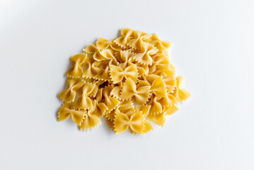 raw tie pasta on white background (farfalle pasta).