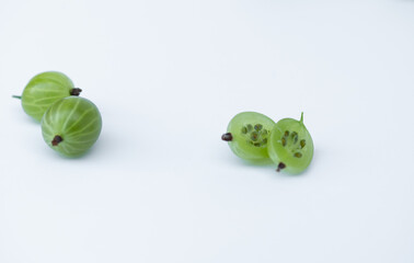 Green gooseberry on white background. Halves of berries.