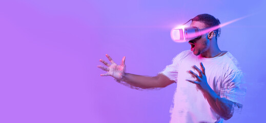 Fototapeta na wymiar Excited African American Man Playing Video Game In VR Glasses
