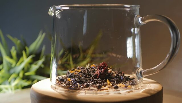 herbal and floral phyto mix of dry herbs is poured into a glass teapot and poured with boiling water to prepare a fragrant tasty drink