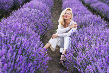 Beautiful girl on the lavender field. Beautiful woman in the lavender field on sunset. 