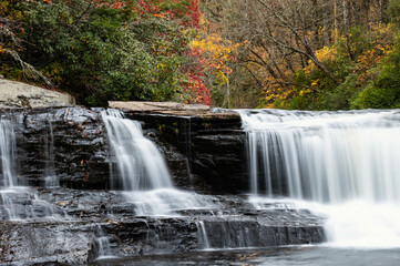 Fototapeta na wymiar Refreshing Waterfall Hidden Deep in the Autumn Forest
