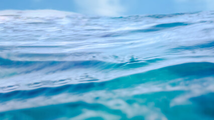A low angle view of the Pacific ocean blue water in Maui Hawaii for a travel or swimming background with copy space