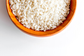 Arboreal rice in bowl, risotto rice in white background top view.