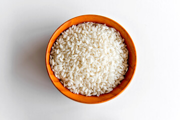 Arboreal rice in bowl, risotto rice in white background.