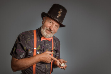 Old watchmaker. Portrait of a kindly elderly man with a pocket watch and a top hat. fairy tale character