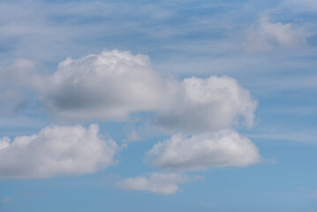 Fluffy white clouds and blue sky