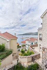 Fototapeta na wymiar View of residential district of Lustica Bay by the sea in Montenegro