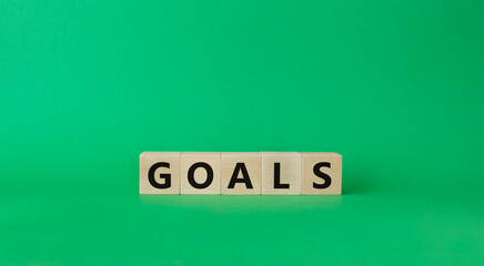 Fototapeta na wymiar Goals symbol. Concept word Goals on wooden cubes. Beautiful green background. Business and Goals concept. Copy space.