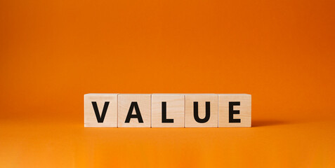 Value symbol. Concept word value on wooden cubes. Beautiful orange background. Business and value concept. Copy space.