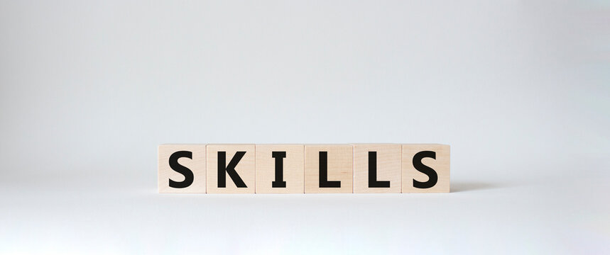 Skills symbol. Concept word Skills on wooden cubes. Beautiful white background. Business and Skills concept. Copy space.
