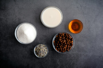 Honey Lavender Cold Brew Latte Ingredients: Overhead view of coffee beans, fried lavender flowers,...
