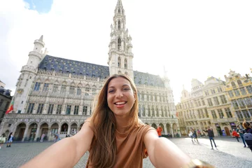Deurstickers Tourism in Brussels. Self portrait of happy traveler girl have fun in Brussels, Belgium. © zigres