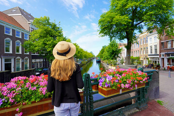 Young tourist woman between flower pots in The Hague, Netherlands