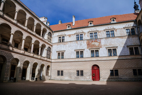 Litomysl, Czech Republic, 17 April 2022: Renaissance aristocratic castle, UNESCO World Heritage Site, chateau with sgraffito mural decorated plaster at facade at sunny day, courtyard with arcades