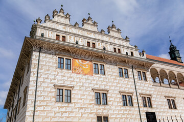 Litomysl, Czech Republic, 17 April 2022: Renaissance castle, UNESCO World Heritage Site, chateau with sgraffito mural decorated plaster at facade at sunny day, medieval historical town, sundial