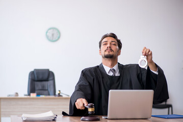 Young male judge working in the courthouse