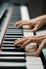 refined woman pianist plays the piano with thin fingers, sensually plays a musical instrument