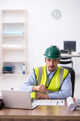 Young male architect working in the office