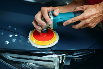 polishing car body with orbital polish machine. detailing workshop, scratch repair