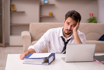 Young male employee working from home during pandemic