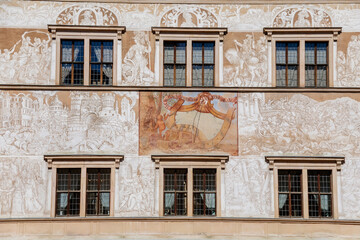 Fototapeta na wymiar Litomysl, Czech Republic, 17 April 2022: Renaissance castle, UNESCO World Heritage Site, chateau with sgraffito mural decorated plaster at facade at sunny day, medieval historical town, sundial