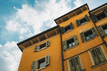 Beautiful old buildings on Verona street, Italy. Amazing blue sky.