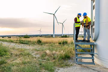 Technician people working on wind farm - Renewable and alternative energy concept