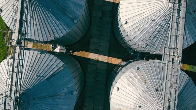 Aerial top voew of Tanks for processing and storage of wheat grain. Harvesting and processing and storage elevator