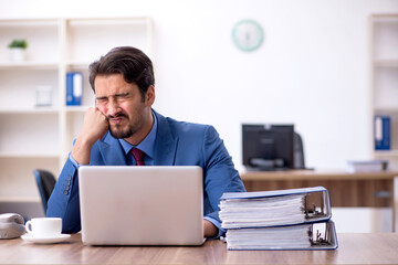 Young male employee working in the office